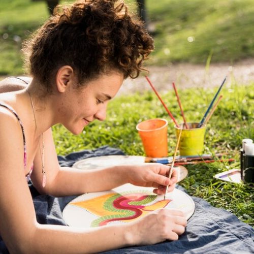 girl-painting-canvas-park_23-2148002542